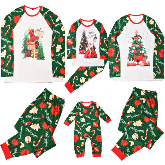 Green baby Christmas pajama romper with red trim, featuring candy canes, ornaments, gingerbread men, and poinsettias.