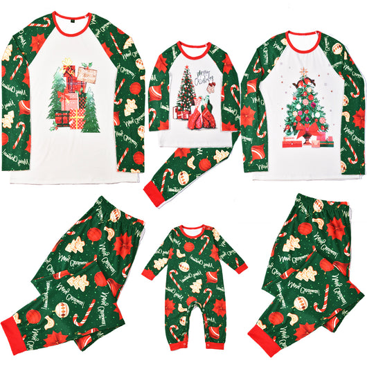 Green baby Christmas pajama romper with red trim, featuring candy canes, ornaments, gingerbread men, and poinsettias.