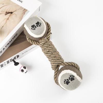 Red, pink, and white braided cotton rope dog toy with a green and red tennis ball featuring black paw prints. - Image 10
