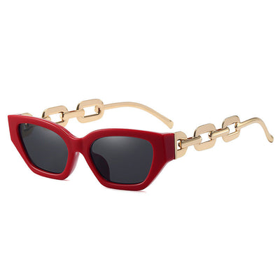 Red cat-eye sunglasses with dark lenses and gold-colored chain link temples on a white background. - Image 6