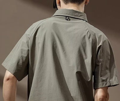 Men's khaki short-sleeve polo shirt with a lapel collar, three buttons, and a large flap chest pocket with a D-ring. - Image 16