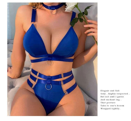 Woman wearing a royal blue strappy lingerie set with O-rings, including a bra, high-waisted bottoms, and a choker. - Image 14