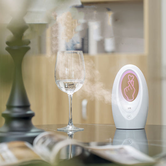 Navy blue USB humidifier with an oval shape and an illuminated castle design in the center. - Image 3