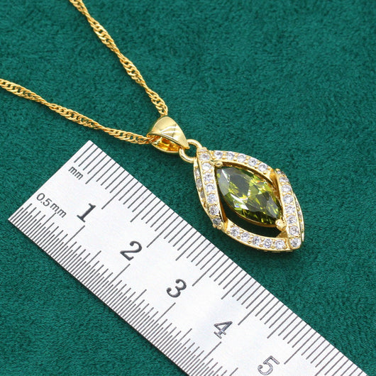 Gold-toned jewelry set with green marquise gemstones and clear accents, including a bracelet, necklace, earrings, and ring. - Image 14