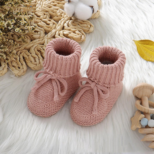 Pink knitted infant toddler shoes with cute bowknots and elastic bands, displayed on a soft white rug. - Image 8