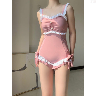 Pink one-piece swimming suit with white ruffles, ruched bust, pearl buttons, and shorts-style bottom with side ties. - Image 8