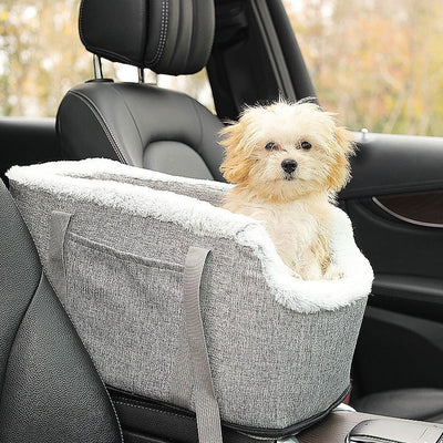 Grey pet car seat with plush white lining, designed for small dogs or cats, placed on a car's center console. - Image 9