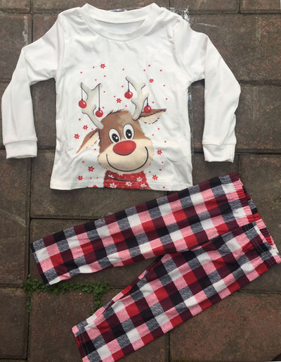 Family of four and a golden retriever wearing matching white long-sleeve reindeer tops and red plaid pajama pants. - Image 18