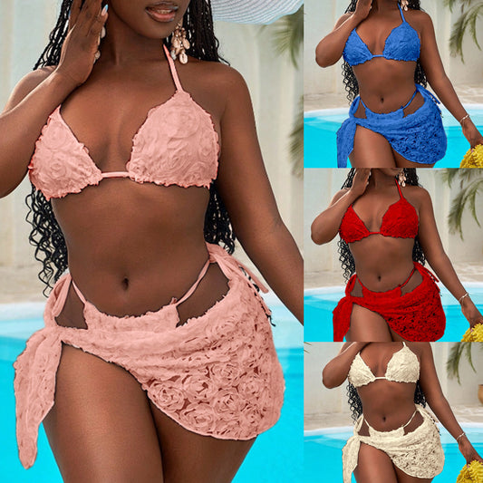Red three-piece bikini set with a halter top, tie-side thong bottom, and sarong, all featuring a raised floral pattern.