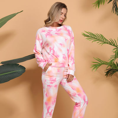 Woman wearing a pink and white tie-dye long-sleeve top and matching pants set, posing casually. - Image 3