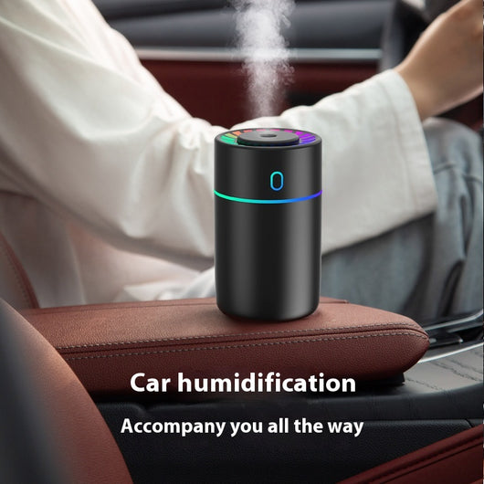 Pink cylindrical humidifier with a colorful LED light ring on top and a blue-green light band around its middle. - Image 3