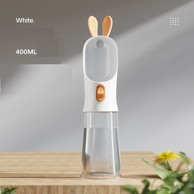 Grey and white portable pet water bottle with clear reservoir, built-in drinking bowl, and decorative bunny ears. - Image 2