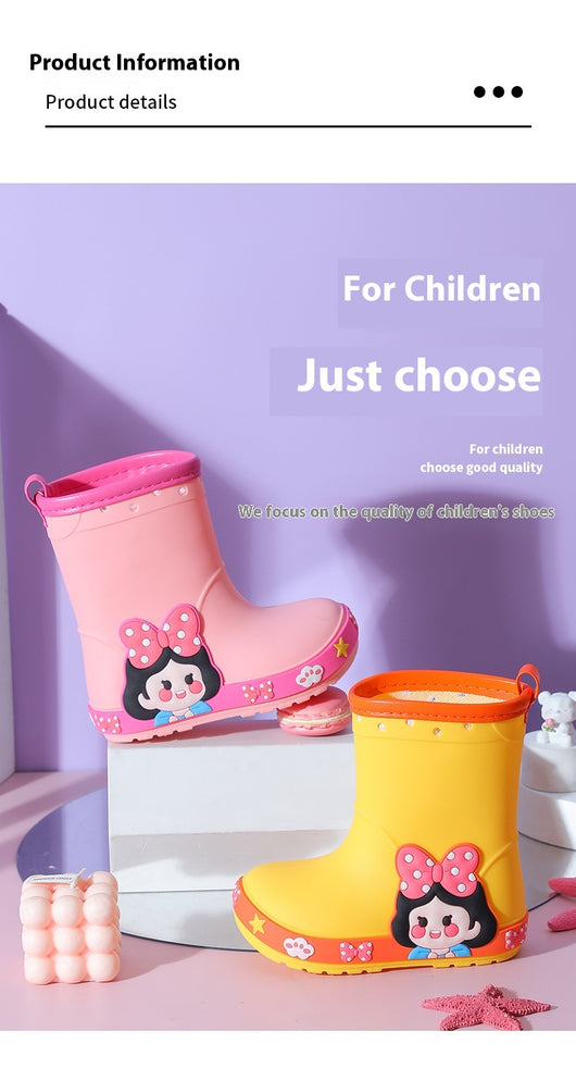 Bright yellow children's rain boots with a green cartoon dinosaur design and orange trim, held by hands. - Image 15