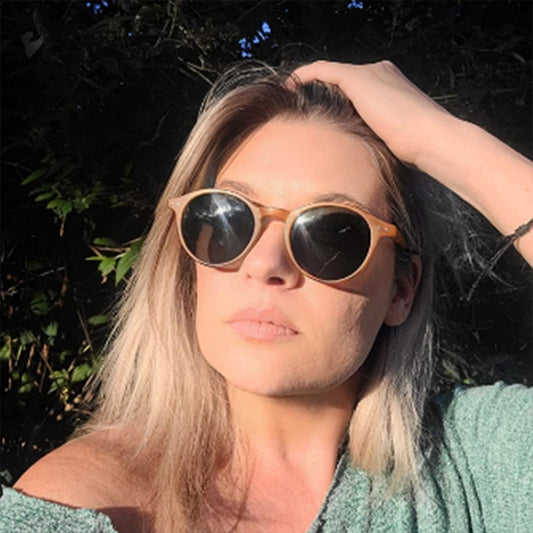 Round black full-rim sunglasses with vibrant blue polarized lenses, ideal for sun protection and fashion.