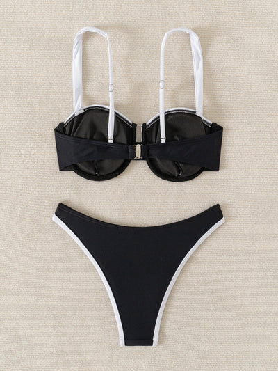 Black and white color block bikini with underwire top and high-cut bottoms, modeled by a woman by a pool. - Image 13