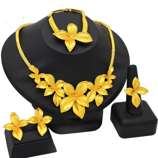 Women's four-piece gold-tone jewelry set with floral designs, including a necklace, bracelet, ring, and earrings. - Image 7