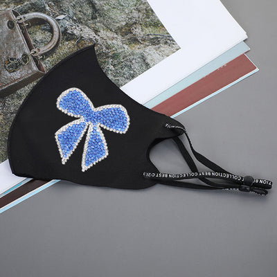 Black ear-mounted mask with a sparkling rhinestone bow pattern, featuring adjustable ear loops. - Image 16