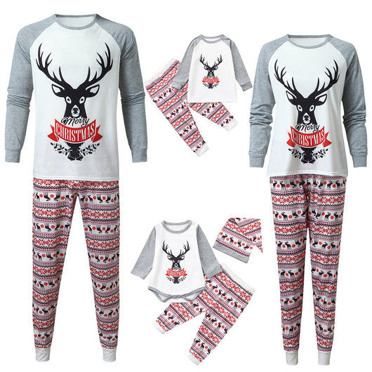 Young boy wearing a Christmas pajama set with a white and grey raglan top featuring a reindeer and fair isle print pants. - Image 3