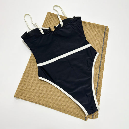 Black one-piece swimsuit with white trim, thin straps, sweetheart neckline, and high-cut leg on a model. - Image 7