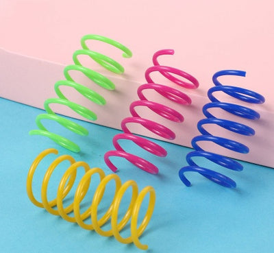 Colorful plastic spring cat toys in pink, yellow, green, and blue, packaged in a clear plastic bag. - Image 12