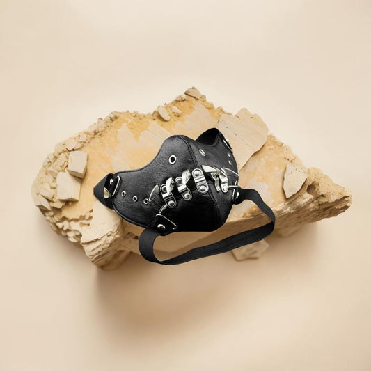 Black leather half-face mask with brass chains, spikes, and gear accents, featuring adjustable elastic straps.