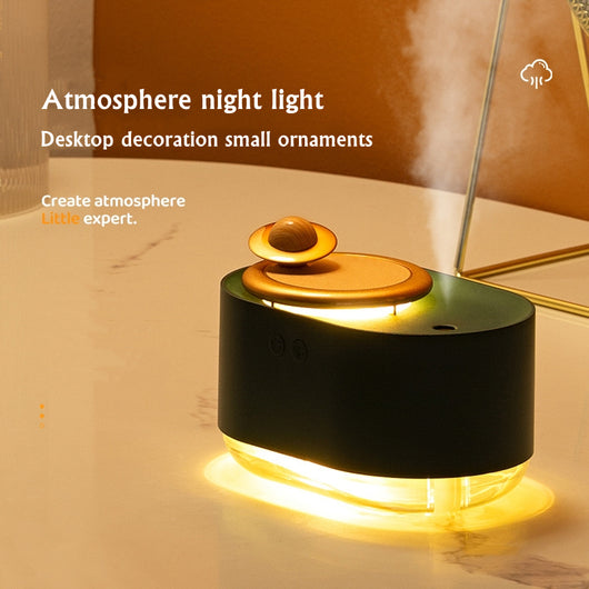 White USB rechargeable mini humidifier with a rose gold top accent and a wooden planet decoration. - Image 10