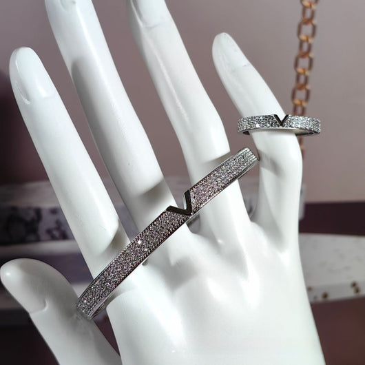 V-shaped 18K gold electroplated bracelet and ring set with pave clear stones on a white stand. - Image 12