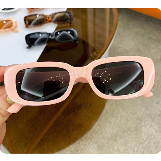 Children's small frame oval sunglasses with a solid white PC frame and brown AC lenses for UV protection. - Image 16