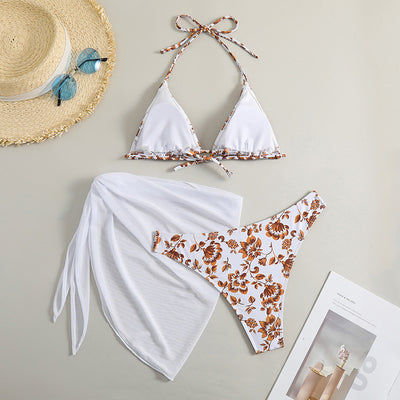 White and yellow floral print three-piece bikini set with a halter triangle top, high-cut bottom, and sheer white sarong. - Image 25