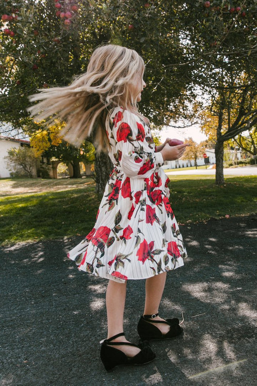 Mother and daughter in matching white dresses with red floral print, V-neck, long sleeves, and tie-waist. - Image 12