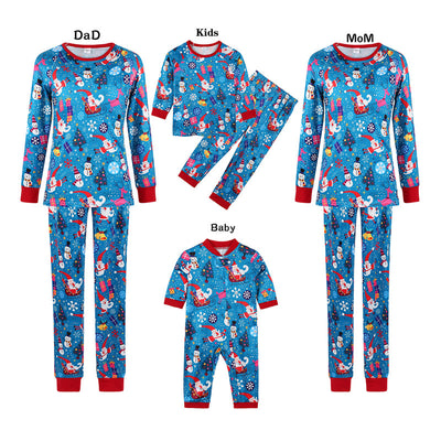 Family matching Christmas pajamas in blue with Santa, snowman, and tree print. Includes adult two-piece sets and a baby romper.
