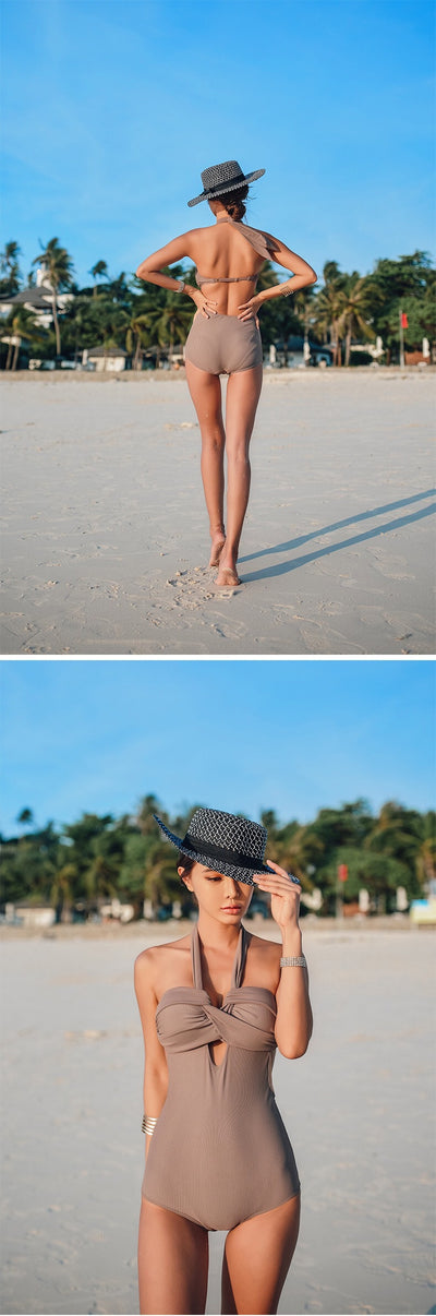 Woman wearing a taupe ribbed one-piece swimsuit with a halter neckline and twisted bust detail on a sandy beach. - Image 18