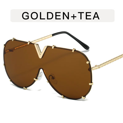 Oversized V-shaped sunglasses with a gold metal frame, white accents, clear lenses, and decorative rivets. - Image 8