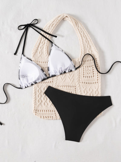 Black and white printed triangular cup tie bikini top with solid black bottoms, displayed with a knit tote bag and sunglasses. - Image 16