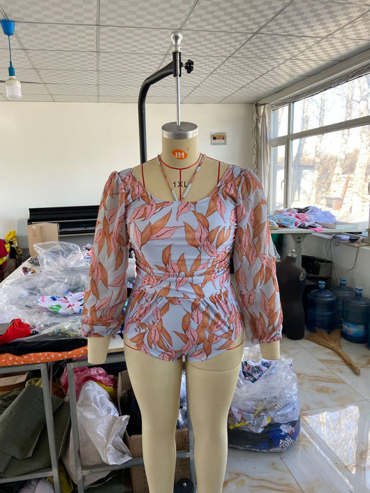 Women's light blue one-piece swimsuit with pink and orange leaf print, long sheer chiffon sleeves, and ruched details. - Image 7