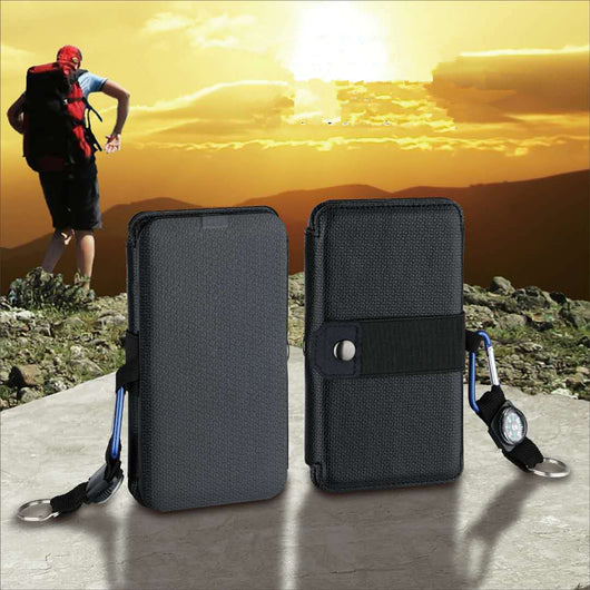 Black portable folding solar panel charger with six panels attached to a backpack in an outdoor setting. - Image 7