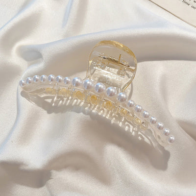 Clear plastic hair claw clip adorned with a single row of white faux pearls and a gold-toned spring. - Image 6
