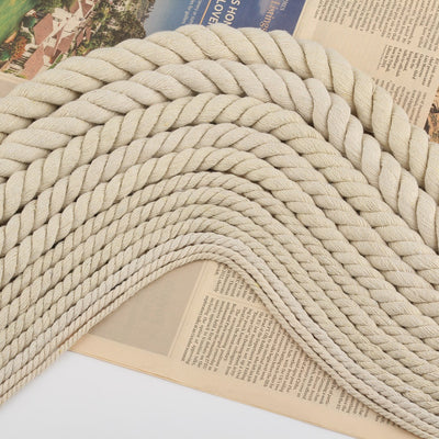 Coiled beige three-strand coarse cotton rope, showcasing its natural texture and thickness on a white background. - Image 4