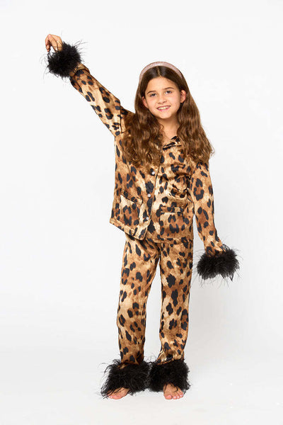 Young girl in a leopard print pajama set with black feather trim on the cuffs and ankles, wearing a pink glitter headband. - Image 18