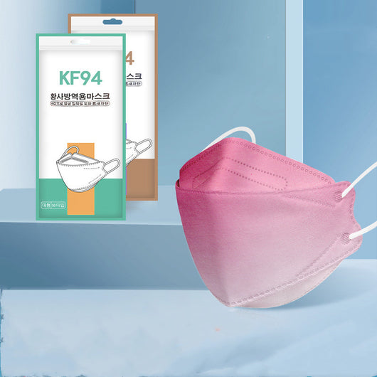 Pink gradient KF94 mask with white ear loops, displayed next to its packaging on a blue background. - Image 2