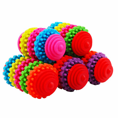 A hand holds a colorful rubber dog toy ball with seven interlocking gear-like rings in purple, orange, green, red, yellow, pink, and blue. - Image 3
