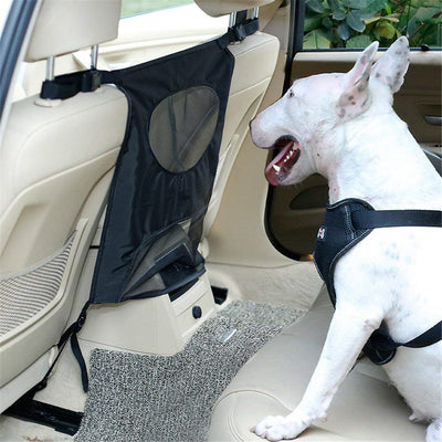 Grey pet car fence installed in a car's rear seat, separating the front and back, with a white Bull Terrier.