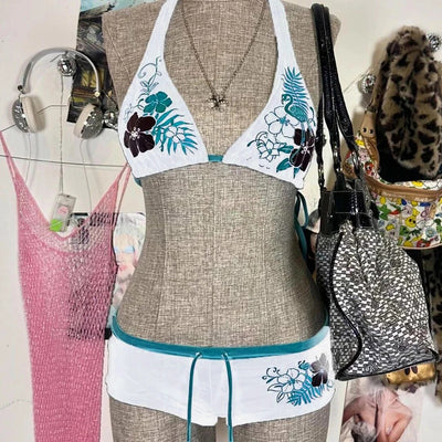 Black halter bikini suit with boy short bottoms, featuring pink and blue floral and flamingo patterns. - Image 7