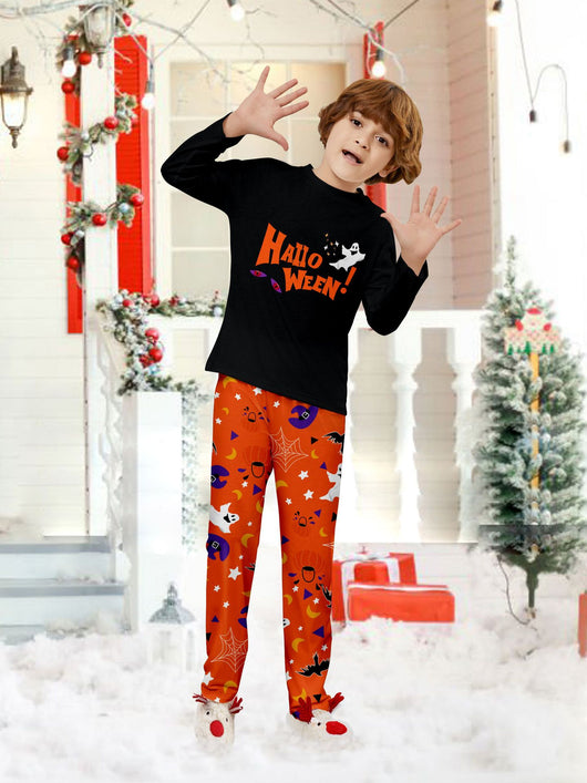 Family of four wearing matching black and orange Halloween long-sleeve pajamas with ghost and bat prints. - Image 15