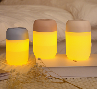 White cylindrical mini humidifier with a soft yellow glow, suitable for air moisturizing and aromatherapy, USB powered. - Image 12