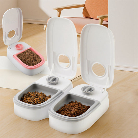 White automatic pet feeder with a pink timer dial and an embossed paw print on the lid. - Image 12