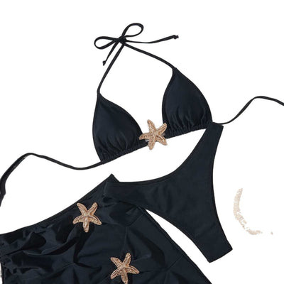 Black three-piece bikini set with triangle top, thong bottom, and skirt, all featuring gold starfish embellishments. - Image 3