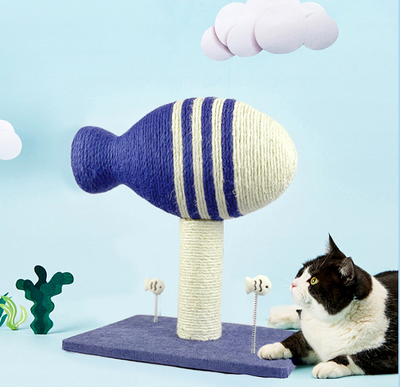 Blue and white striped fish-shaped sisal cat scratching post with a purple base, next to a black and white cat. - Image 12