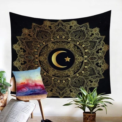 Black tapestry with a gold mandala pattern and a central crescent moon and star design, hanging on a white wall.
