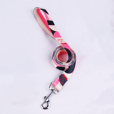 Pink, black, and white patterned polyester dog leash with a silver metal swivel snap hook, coiled on a white background. - Image 7